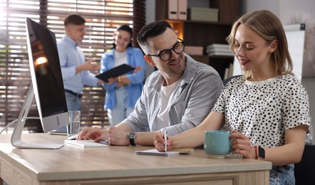 Photo of Marketing. Businesspeople working together at desk in office, selective focus