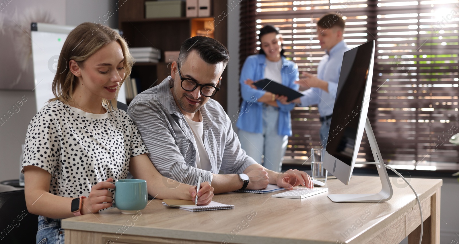 Marketing. Businesspeople working together at desk in office, selective focus Photo of Marketing. Businesspeople working together at desk in office, selective focus
