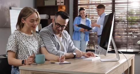 Photo of Marketing. Businesspeople working together at desk in office, selective focus