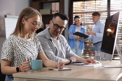Photo of Marketing. Businesspeople working together at desk in office, selective focus