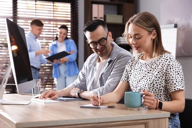 Photo of Marketing. Businesspeople working together at desk in office, selective focus