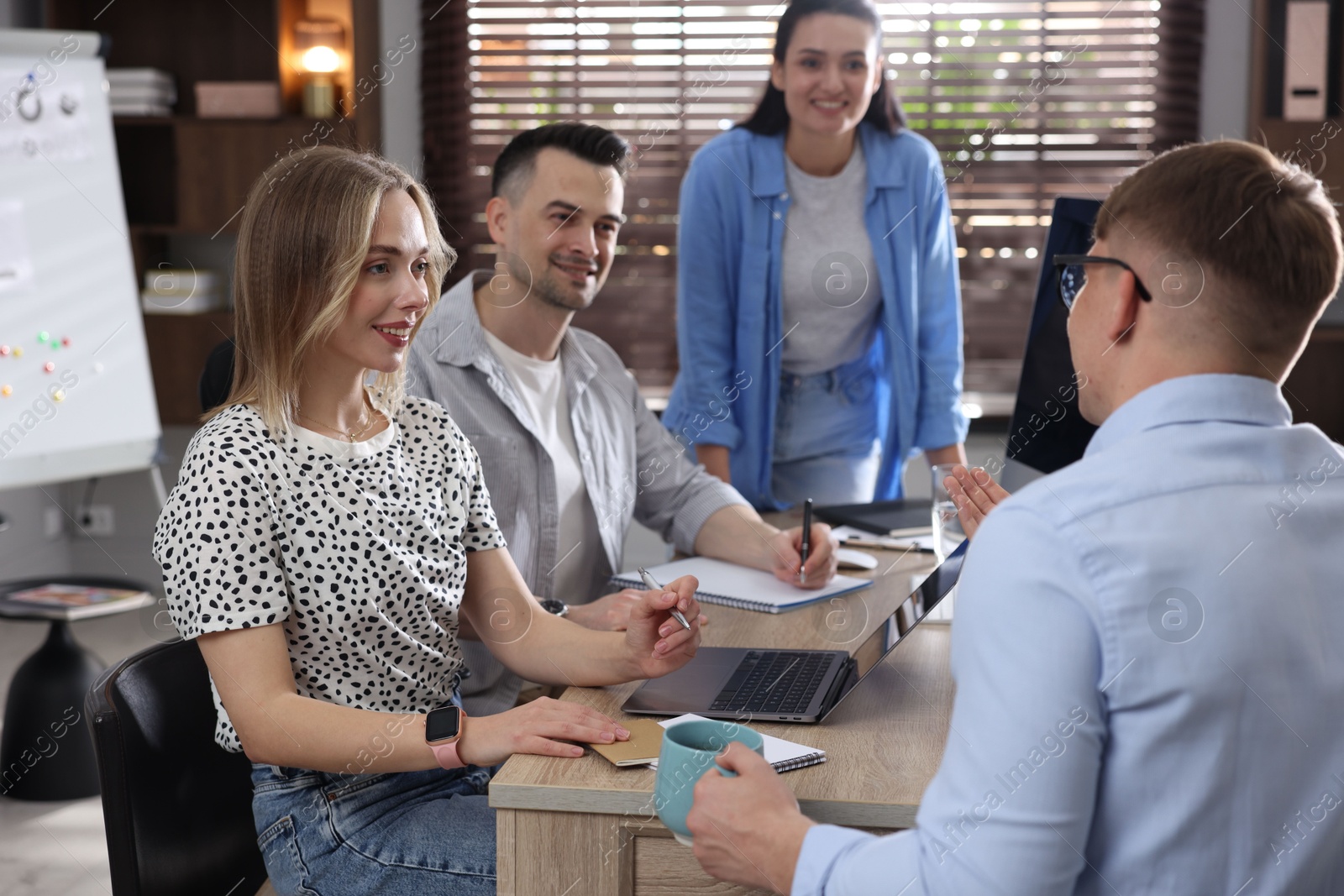Marketing. Team of businesspeople working together at desk in office Photo of Marketing. Team of businesspeople working together at desk in office