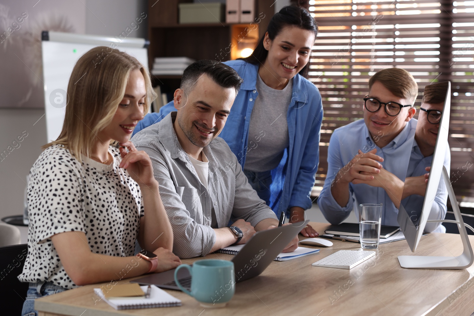 Marketing. Team of businesspeople working together at desk in office Photo of Marketing. Team of businesspeople working together at desk in office