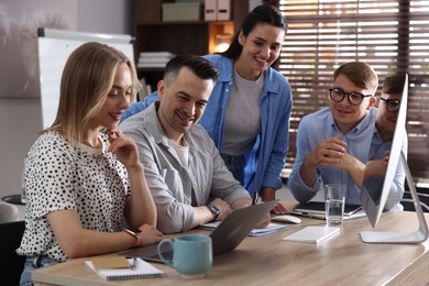 Photo of Marketing. Team of businesspeople working together at desk in office
