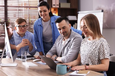 Photo of Marketing. Team of businesspeople working together at desk in office
