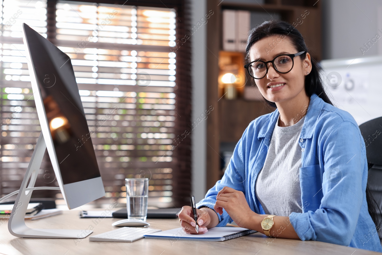 Marketing. Woman working at desk in office Photo of Marketing. Woman working at desk in office