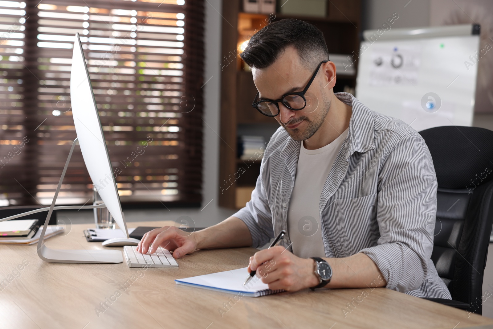 Marketing. Man working at desk in office Photo of Marketing. Man working at desk in office