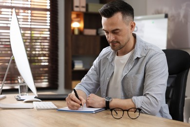 Photo of Marketing. Man working at desk in office