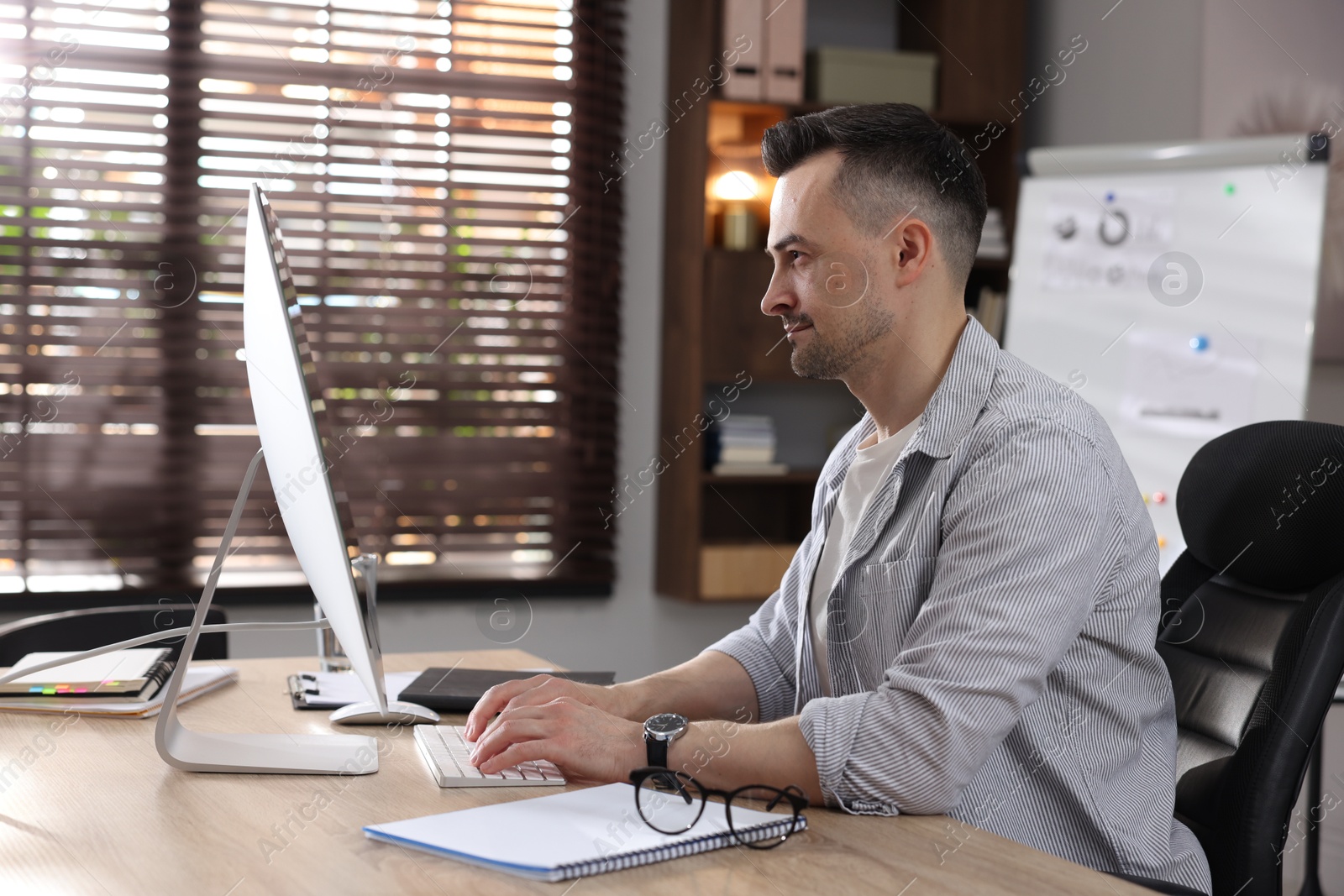 Marketing. Man working on computer at desk in office Photo of Marketing. Man working on computer at desk in office