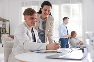 Photo of Marketing. Businesspeople working together in office, selective focus
