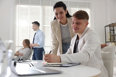 Photo of Marketing. Businesspeople working together in office, selective focus