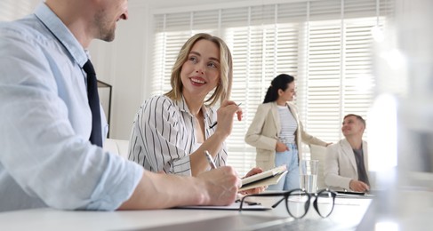 Photo of Marketing. Businesspeople working together in office, selective focus