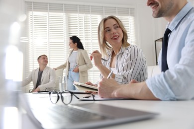 Photo of Marketing. Businesspeople working together in office, selective focus