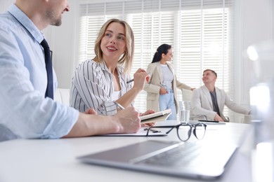 Photo of Marketing. Businesspeople working together in office, selective focus