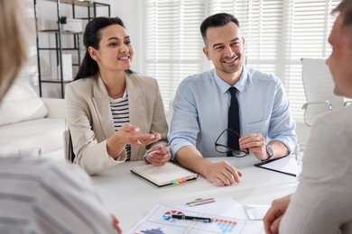 Photo of Marketing. Team of businesspeople working together at desk in office