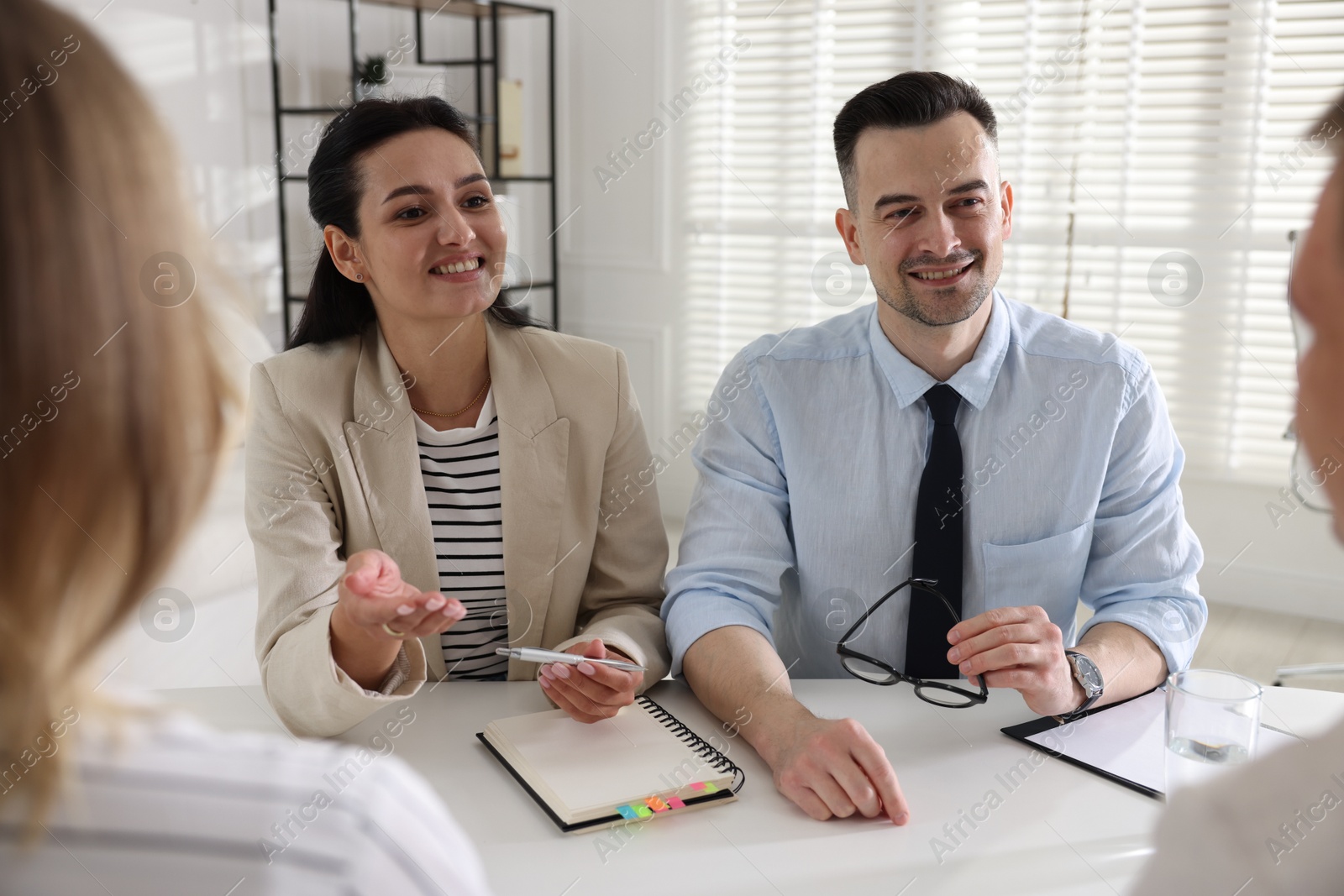 Marketing. Team of businesspeople working together at desk in office Photo of Marketing. Team of businesspeople working together at desk in office