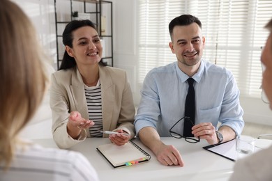 Photo of Marketing. Team of businesspeople working together at desk in office