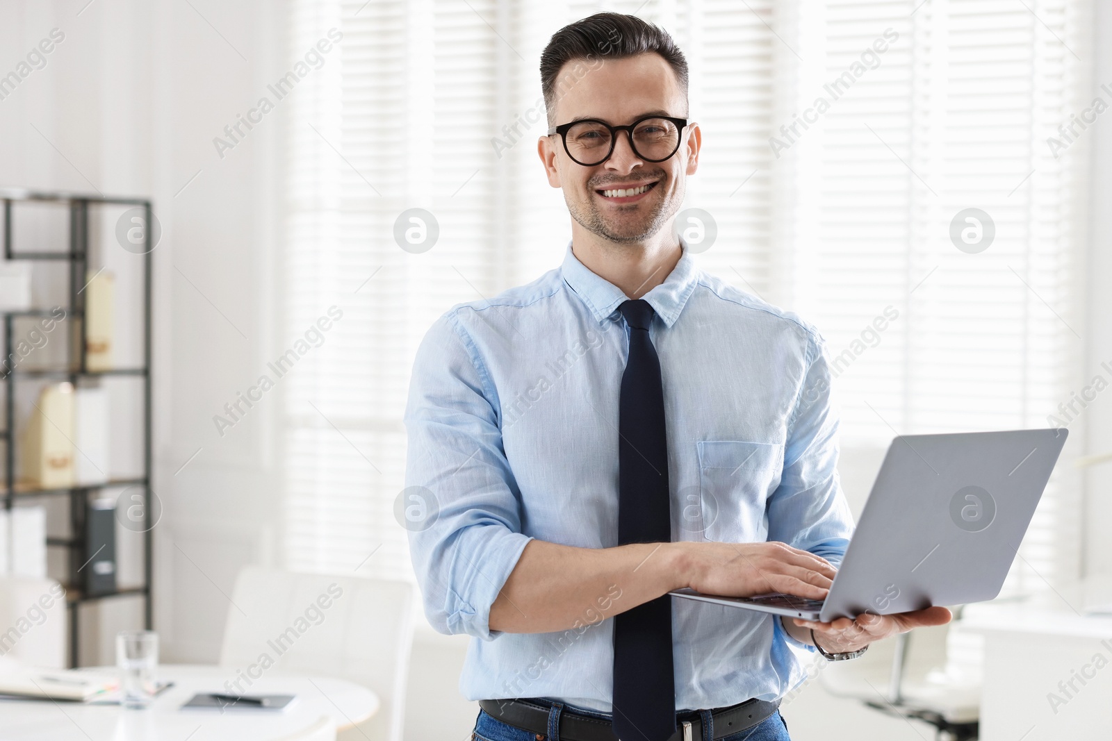 Marketing. Happy man with laptop in office, space for text Photo of Marketing. Happy man with laptop in office, space for text