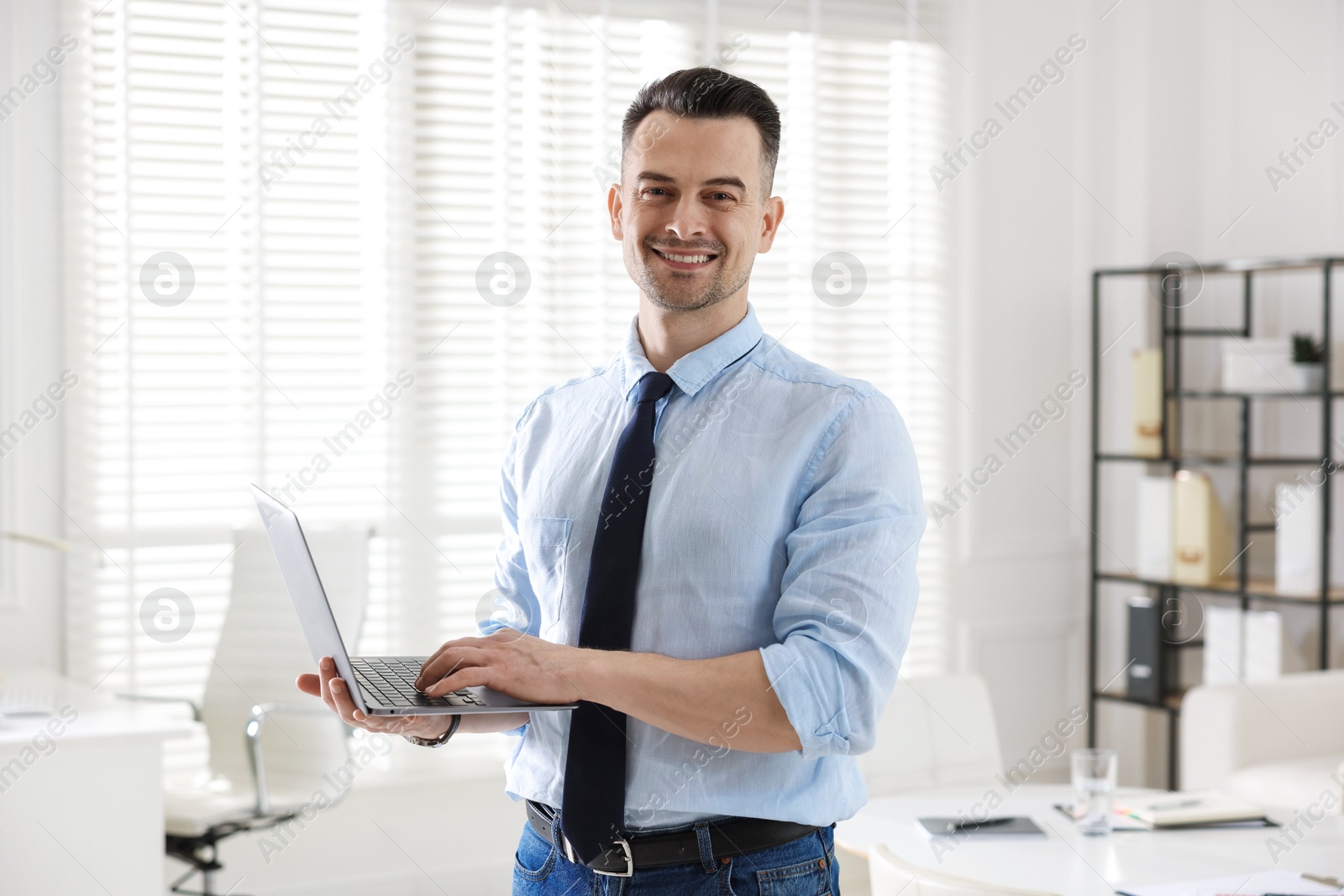 Marketing. Happy man with laptop in office Photo of Marketing. Happy man with laptop in office