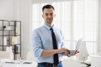 Photo of Marketing. Smiling man with laptop in office