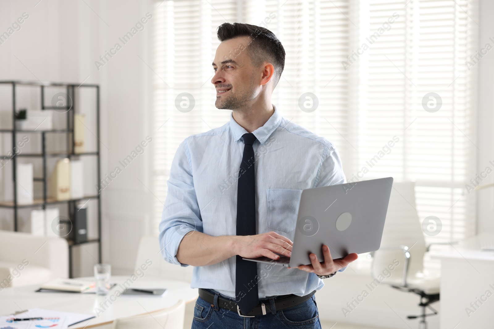 Marketing. Happy man with laptop in office Photo of Marketing. Happy man with laptop in office