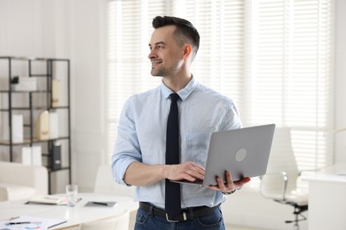 Photo of Marketing. Happy man with laptop in office