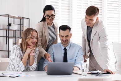 Photo of Marketing. Team of businesspeople working together at desk in office