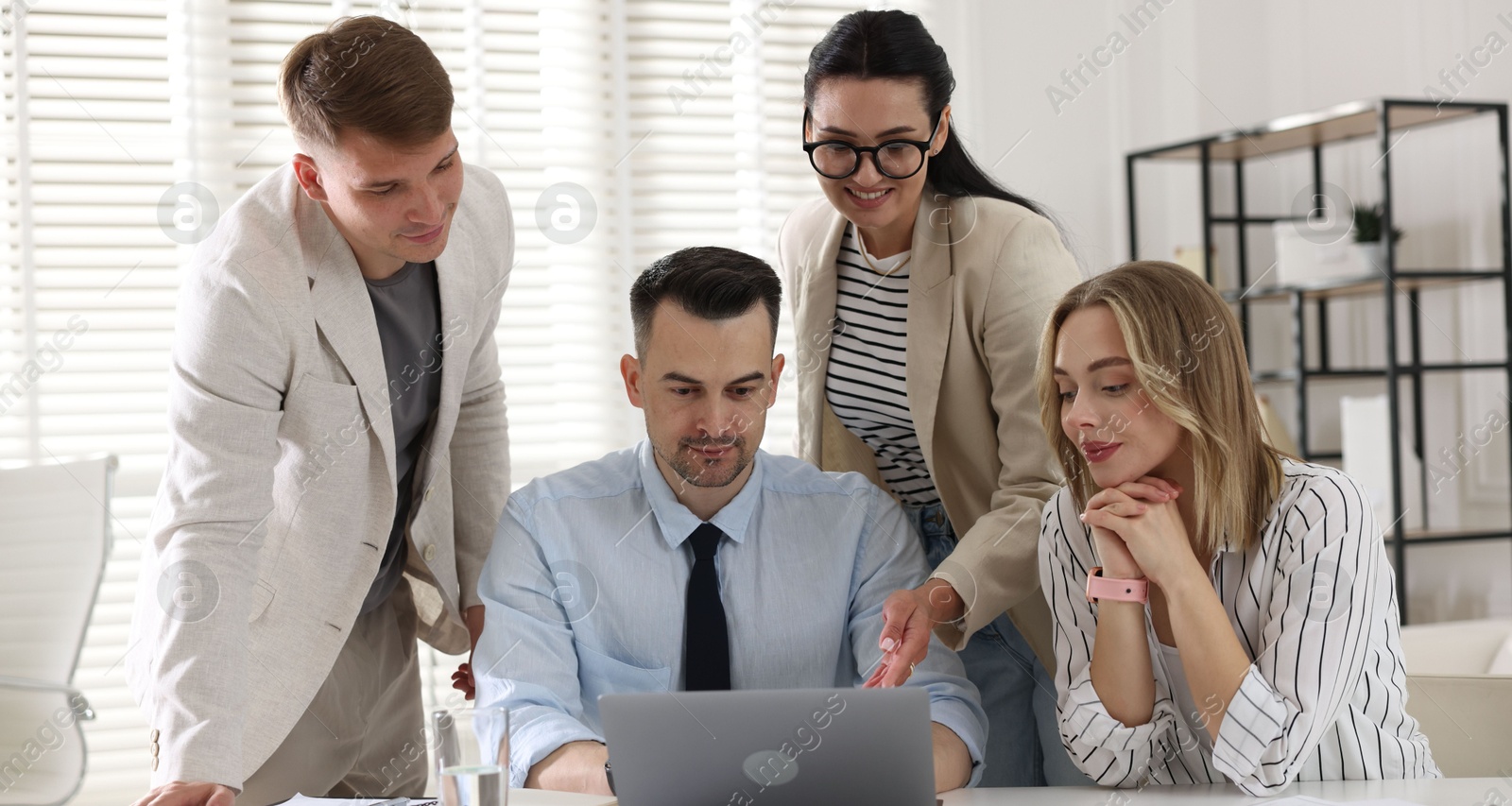 Marketing. Team of businesspeople working together at desk in office Photo of Marketing. Team of businesspeople working together at desk in office