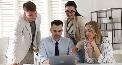 Photo of Marketing. Team of businesspeople working together at desk in office