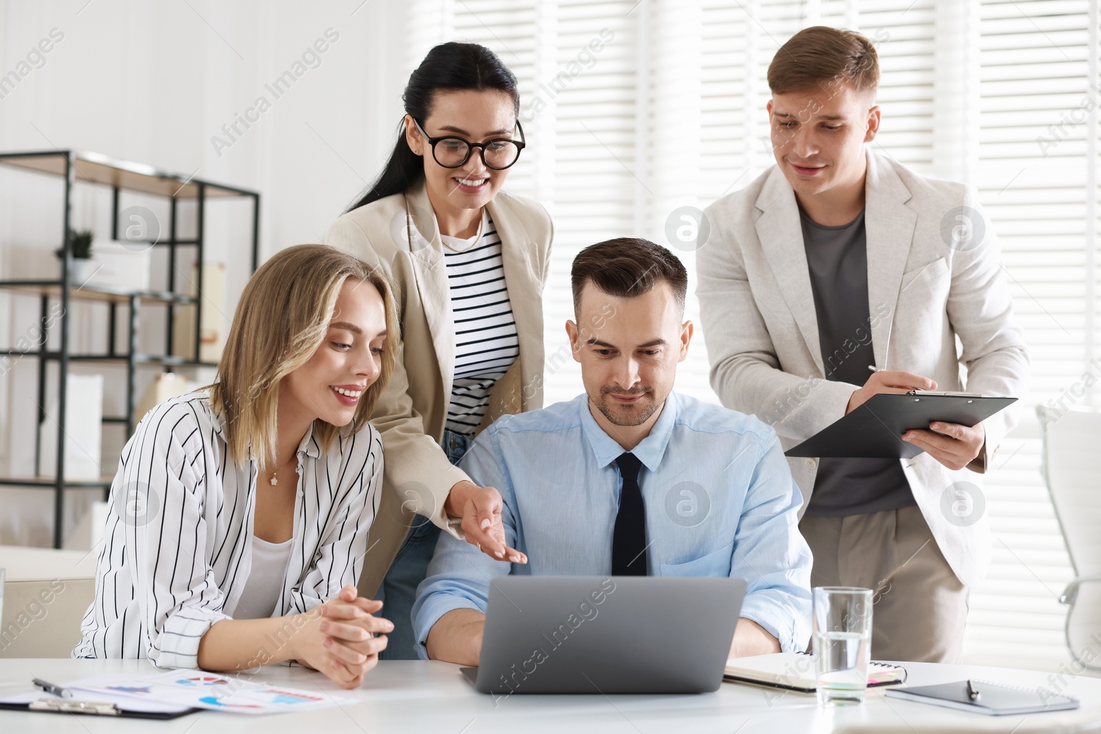Marketing. Team of businesspeople working together at desk in office Photo of Marketing. Team of businesspeople working together at desk in office