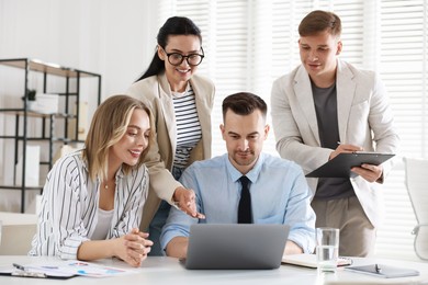 Photo of Marketing. Team of businesspeople working together at desk in office
