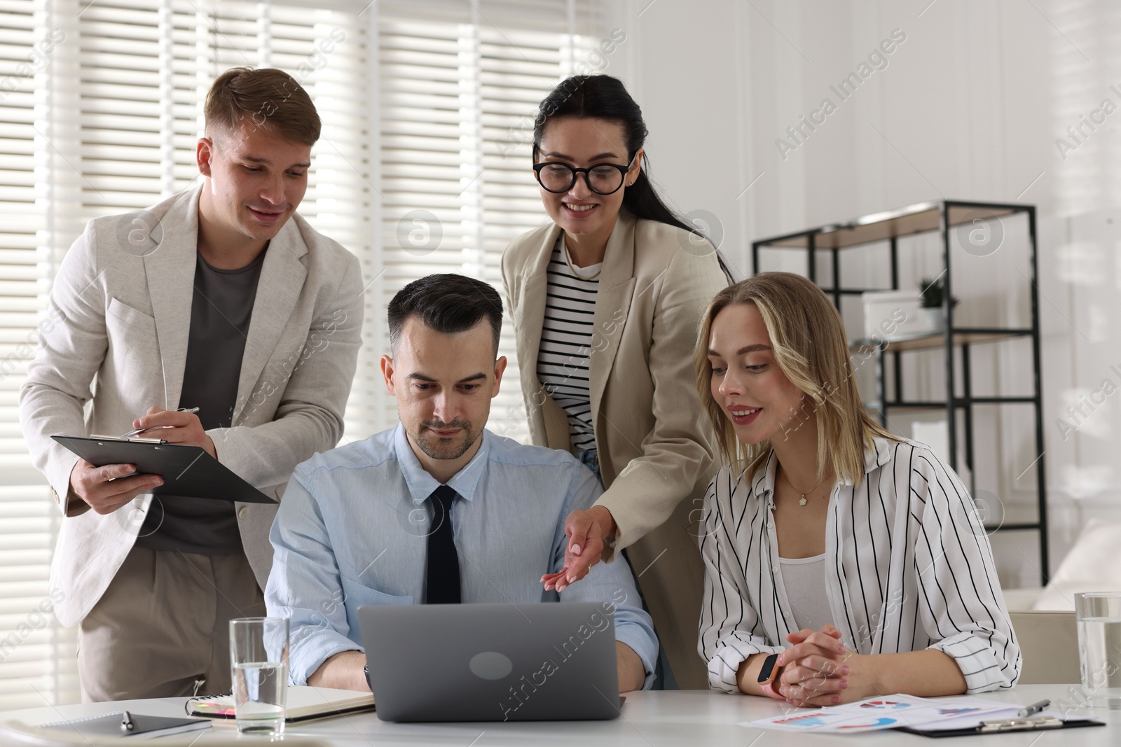 Marketing. Team of businesspeople working together at desk in office Photo of Marketing. Team of businesspeople working together at desk in office