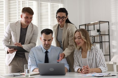 Photo of Marketing. Team of businesspeople working together at desk in office