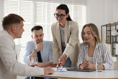 Photo of Marketing. Team of businesspeople working together at desk in office