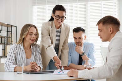 Photo of Marketing. Team of businesspeople working together at desk in office