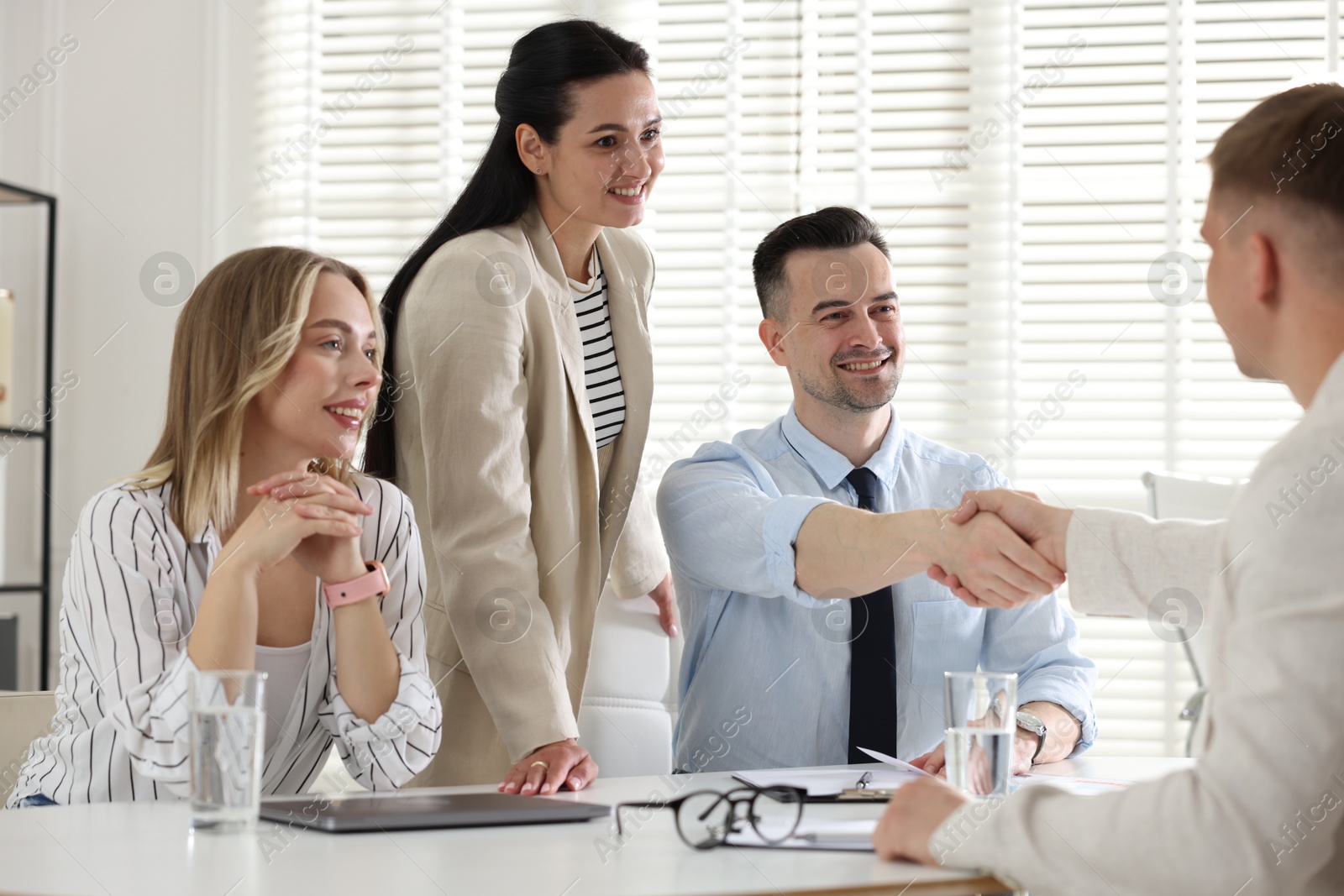 Marketing. Team of businesspeople working together at desk in office Photo of Marketing. Team of businesspeople working together at desk in office