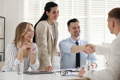 Photo of Marketing. Team of businesspeople working together at desk in office