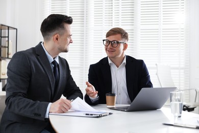 Photo of Marketing. Two colleagues working together in office