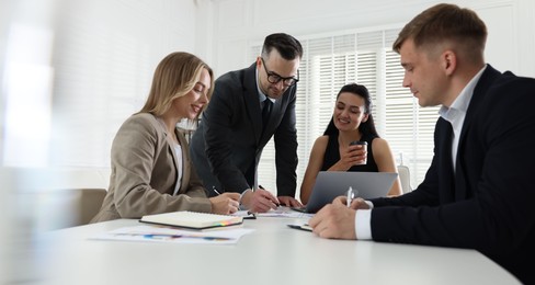 Photo of Marketing. Team of businesspeople working together at desk in office