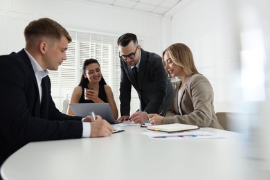Photo of Marketing. Team of businesspeople working together at desk in office