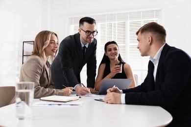 Photo of Marketing. Team of businesspeople working together at desk in office