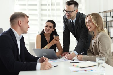 Photo of Marketing. Team of businesspeople working together at desk in office