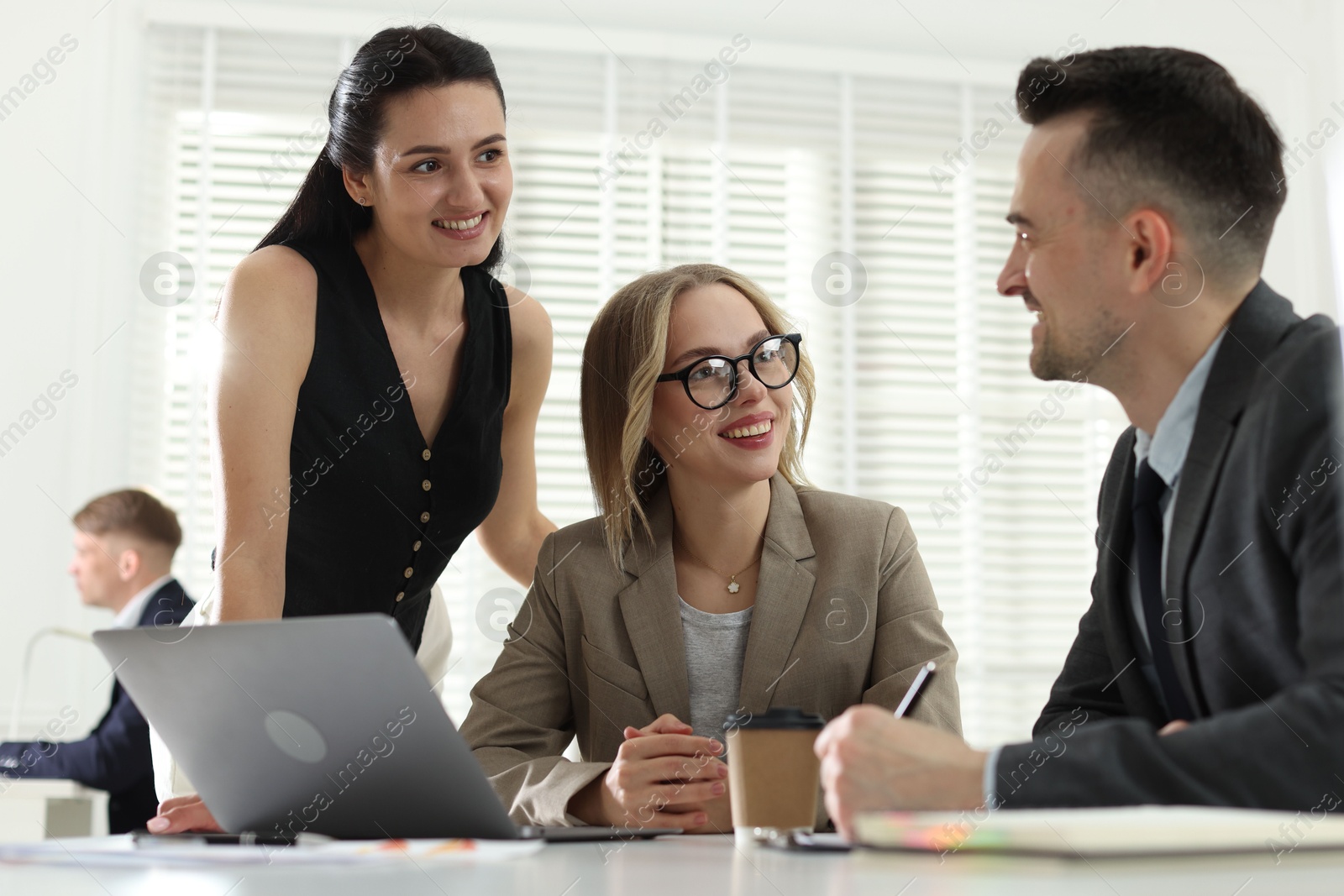 Marketing. Team of businesspeople working together at desk in office Photo of Marketing. Team of businesspeople working together at desk in office