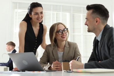 Photo of Marketing. Team of businesspeople working together at desk in office