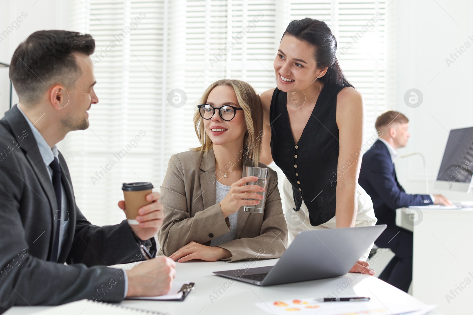 Marketing. Team of businesspeople working together at desk in office Photo of Marketing. Team of businesspeople working together at desk in office