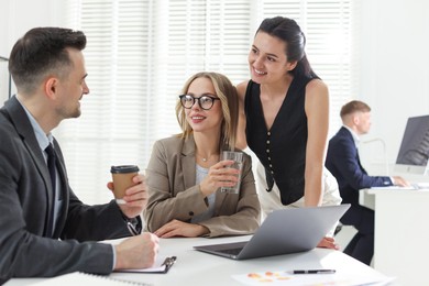 Photo of Marketing. Team of businesspeople working together at desk in office