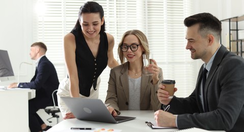 Photo of Marketing. Team of businesspeople working together at desk in office
