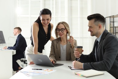Photo of Marketing. Team of businesspeople working together at desk in office