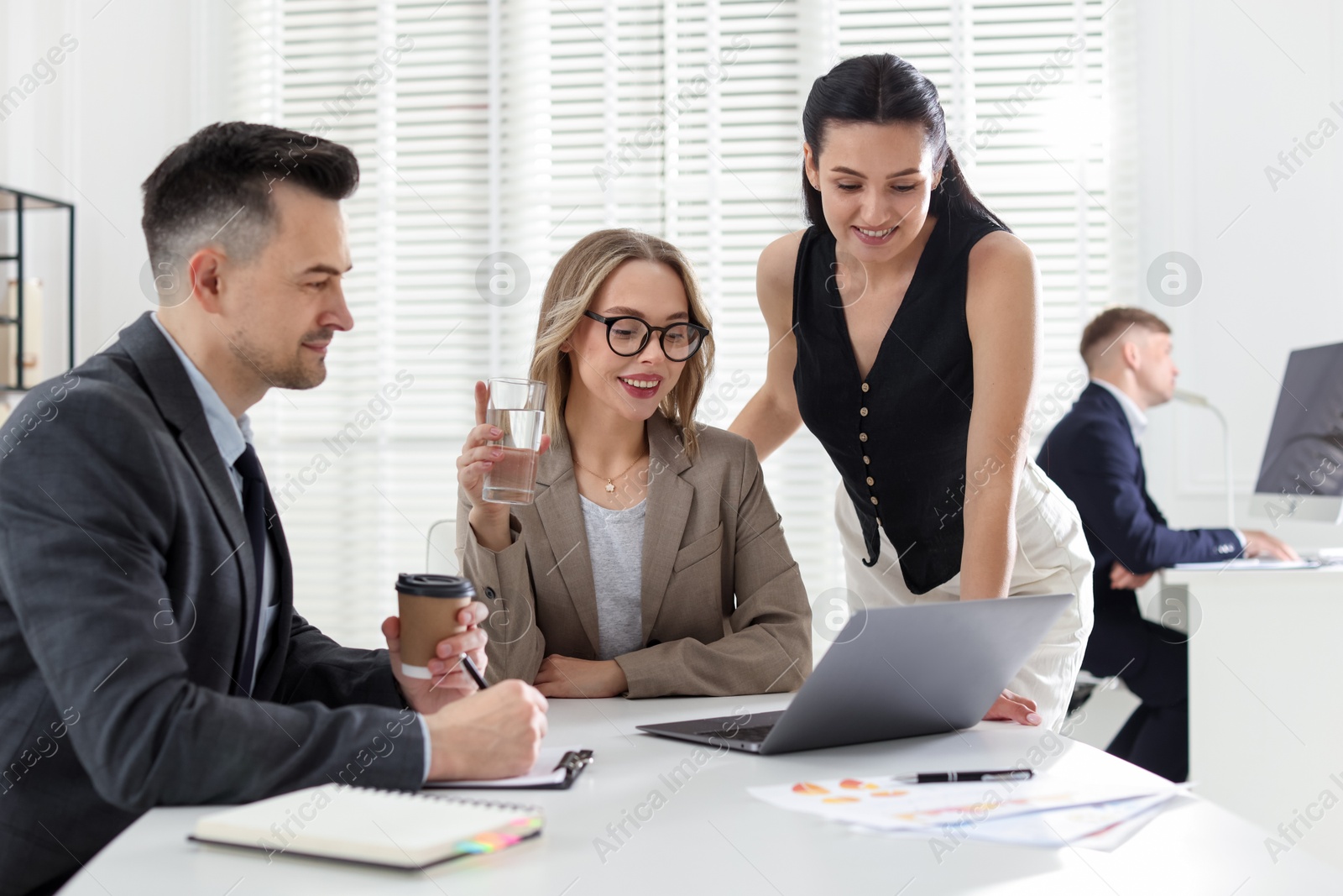 Marketing. Team of businesspeople working together at desk in office Photo of Marketing. Team of businesspeople working together at desk in office