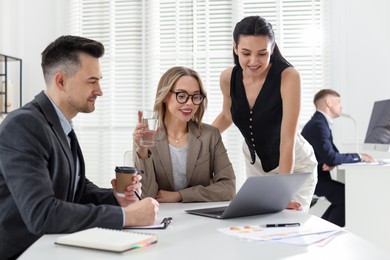 Photo of Marketing. Team of businesspeople working together at desk in office